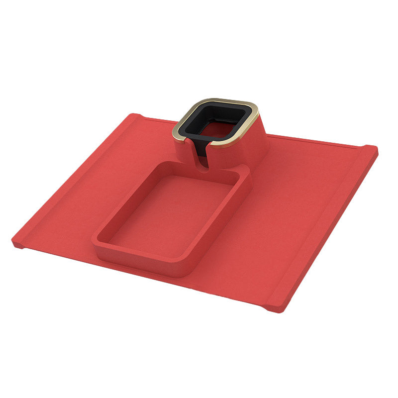 Red silicone sofa coaster with gold-trimmed cup holder and tray, combining modern design with practical beverage and snack storage.