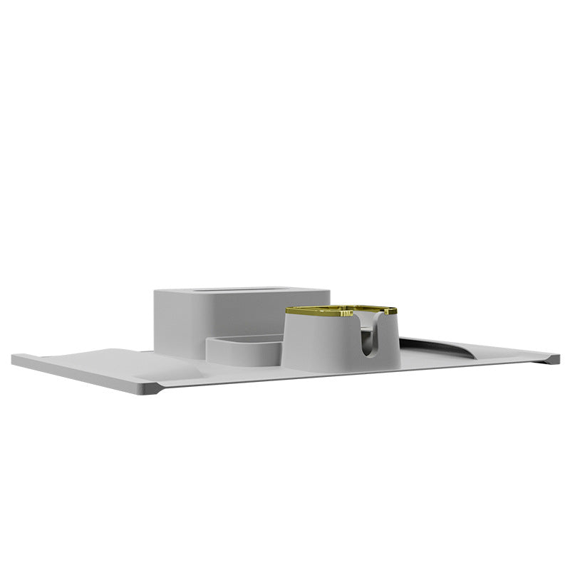 Side view of gray silicone sofa coaster with integrated tray and gold-edged cup holder, designed for stylish and stable drink placement.