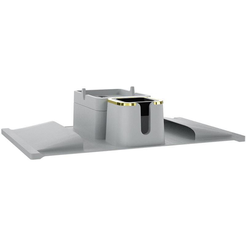 Gray silicone sofa coaster with gold-trimmed cup holder and tray, designed for stable drink placement on sofa armrests.