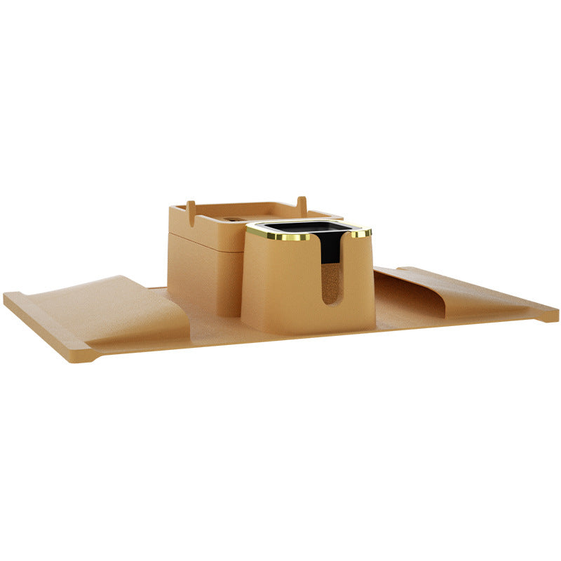 Brown silicone sofa armrest cup holder with gold-accented cup slot and tray, offering a creative and practical living room solution.