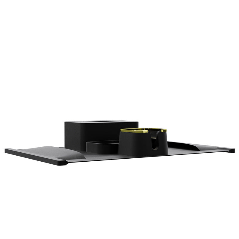 Side view of black silicone sofa cup holder with flat tray and gold-trimmed drink slot, perfect for modern minimalist interiors.